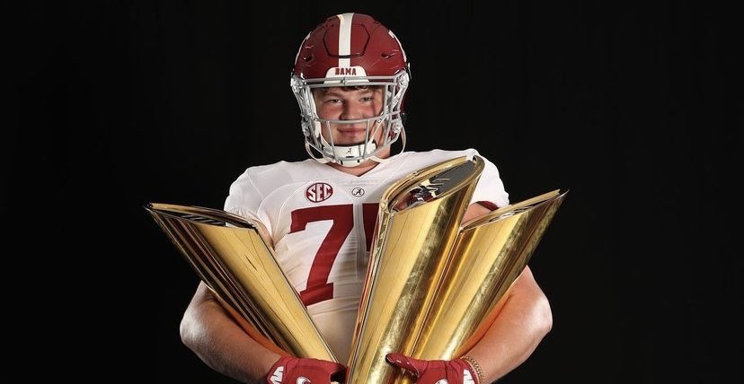 Wilkin Formby holds alabama CFP National Championship trophy during official visit