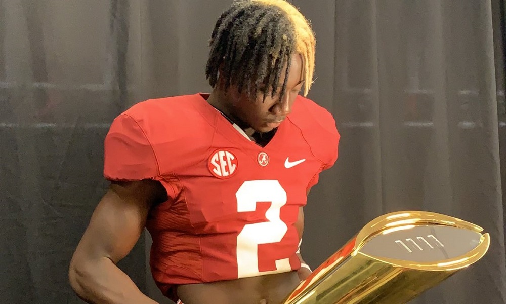 Ellis Robinson holds alabama trophies during alabama visit