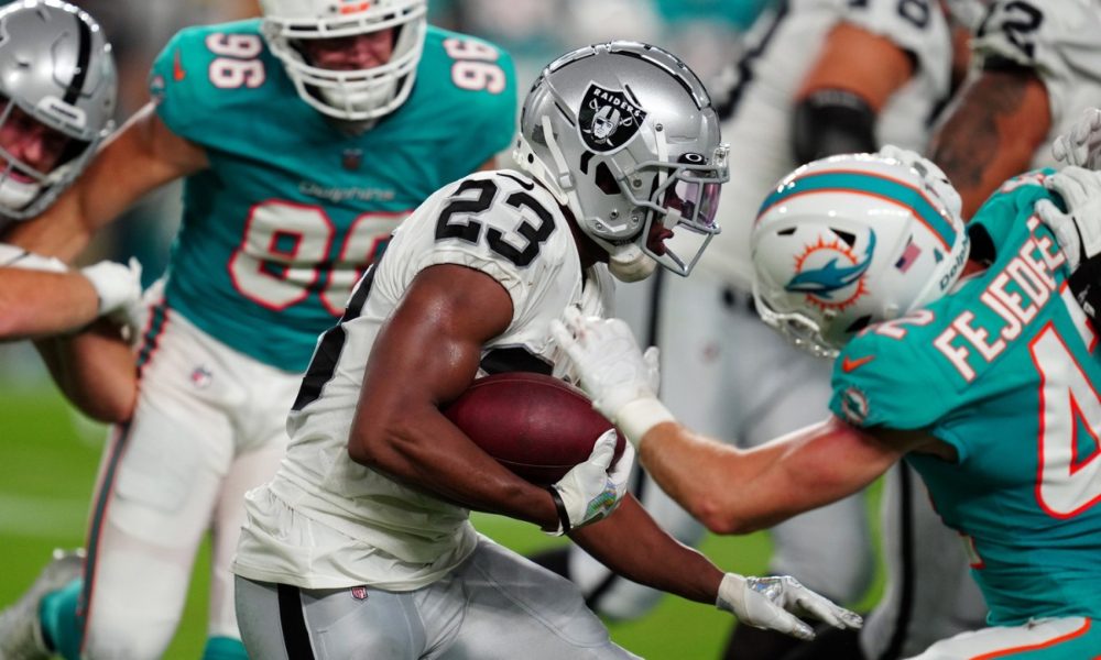 Kenyan Drake carries the ball against the Dolphins