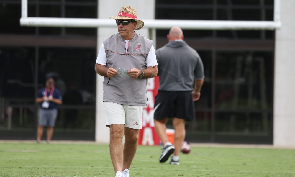 Nick Saban walks the practice field