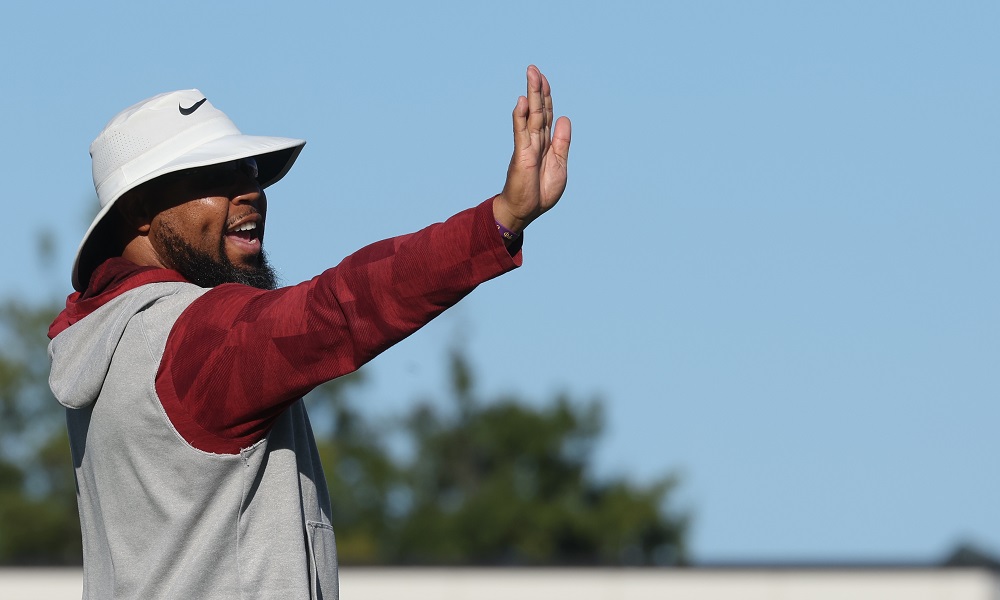 Alabama RB coach Robert Gillespie giving signals during practice in 2022.
