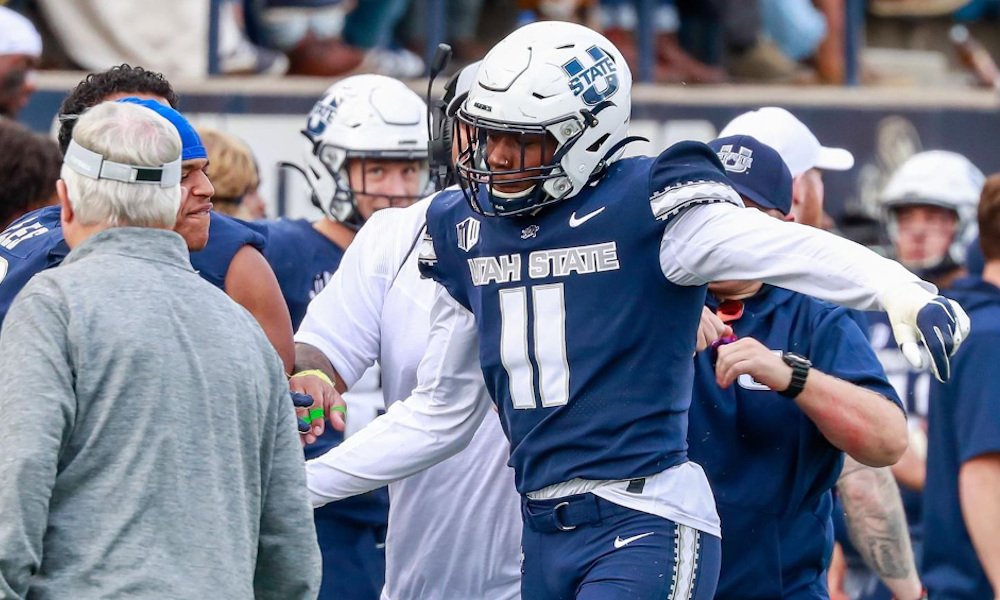 DE Byron Vaughns (#11) going to the sideline for Utah State in 2021