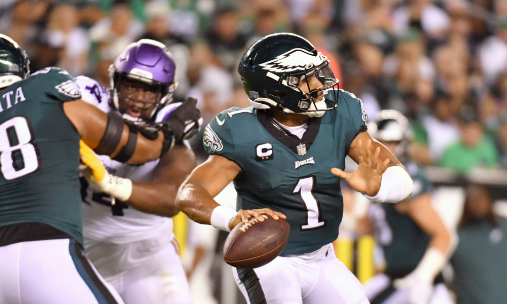 Jalen Hurts (#1) throws a touchdown pass for Eagles versus Vikings on Monday Night Football