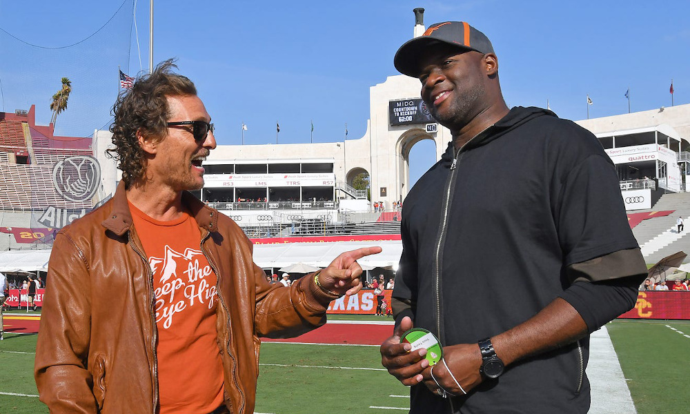 Academy-Award winning actor Matthew McConaughey on the field with Texas legend Vince Young in 2017 before USC game
