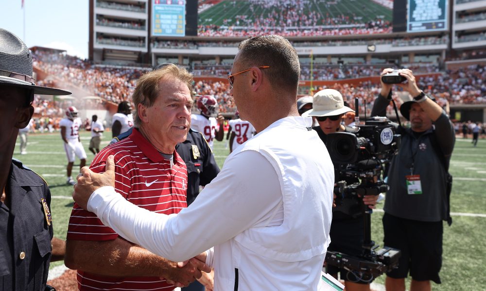 Nick Saban greets Steve Sarkisian at mid field