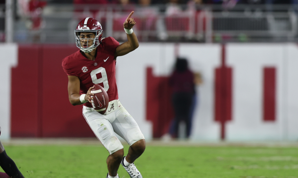 Alabama QB Bryce Young (#9) directs wide receivers downfield against Mississippi State