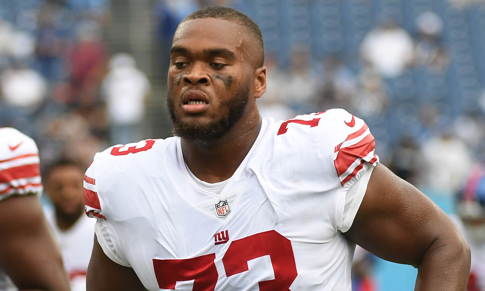 Giants' OT Evan Neal (#73) leaves the field after pregame warmups for 2022 game against Titans