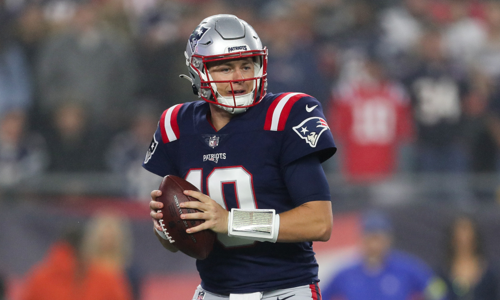 Mac Jones (#10) drops back to pass for New England in 2022 matchup against Chicago Bears