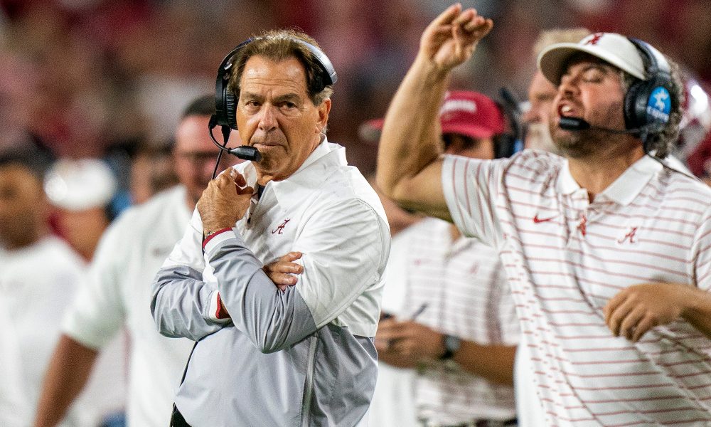 Nick Saban looks to the field next to Pete Golding