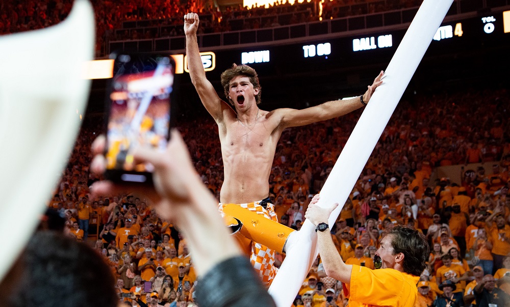A Tennessee fan cheers after climbing the downed goal posts. Syndication The Knoxville News Sentinel