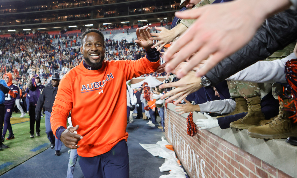 Auburn interim head coach Carnell Williams celebrates with Tiger fans after a victory over Western Kentucky.