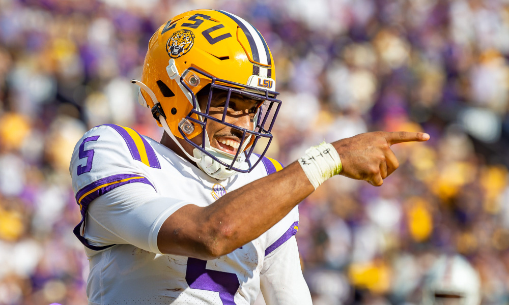 LSU quarterback Jayden Daniels (#5) celebrates after scoring a touchdown in 2022 game versus Ole Miss