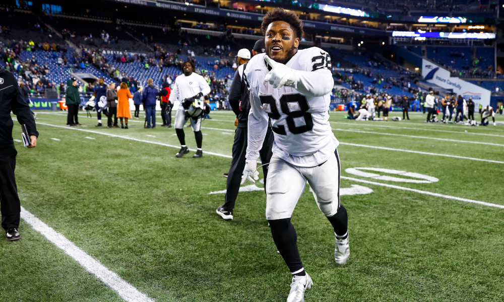 Las Vegas Raiders RB Josh Jacobs (#28) celebrates game-winning 86-yard TD run in overtime against Seattle Seahawks.