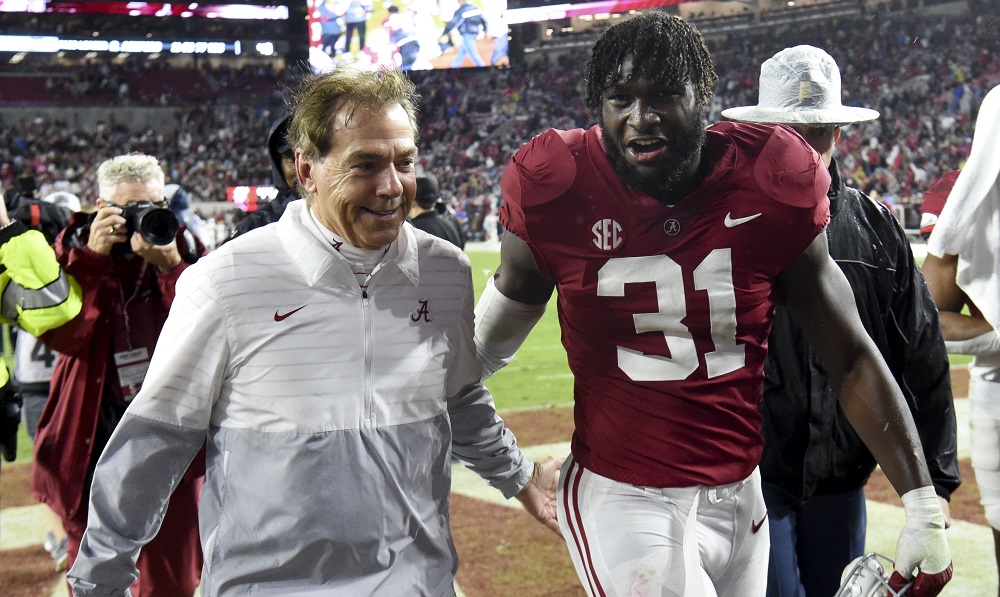 Nov 26, 2022; Tuscaloosa, Alabama, USA; Alabama Crimson Tide head coach Nick Saban and linebacker Will Anderson Jr. (31) share a smile as they leave the field after defeating the Auburn Tigers at Bryant-Denny Stadium. Alabama won 49-27. Mandatory Credit: Gary Cosby Jr.-USA TODAY Sports