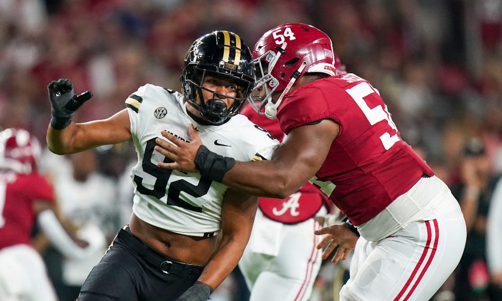 Tyler Steen blocks a Vanderbilt defender