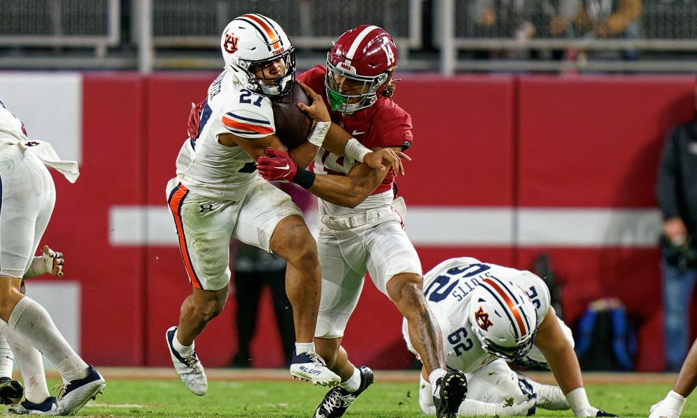 Brian Branch makes a tackle against Auburb