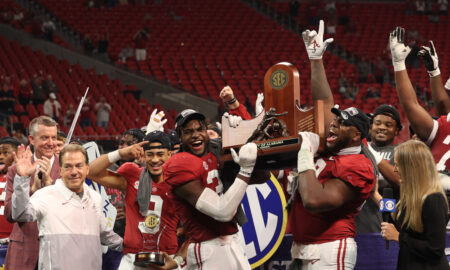 Alabama QB Bryce Young (#9) and Will Anderson Jr. (#31) celebrate 2021 SEC Championship with teammates.