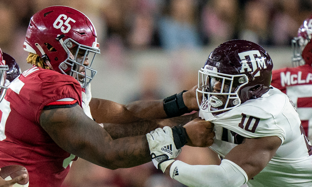 Alabama offensive tackle JC Latham (#65) blocks Texas A&M's DL Fadil Diggs (#10) during 2022 matchup