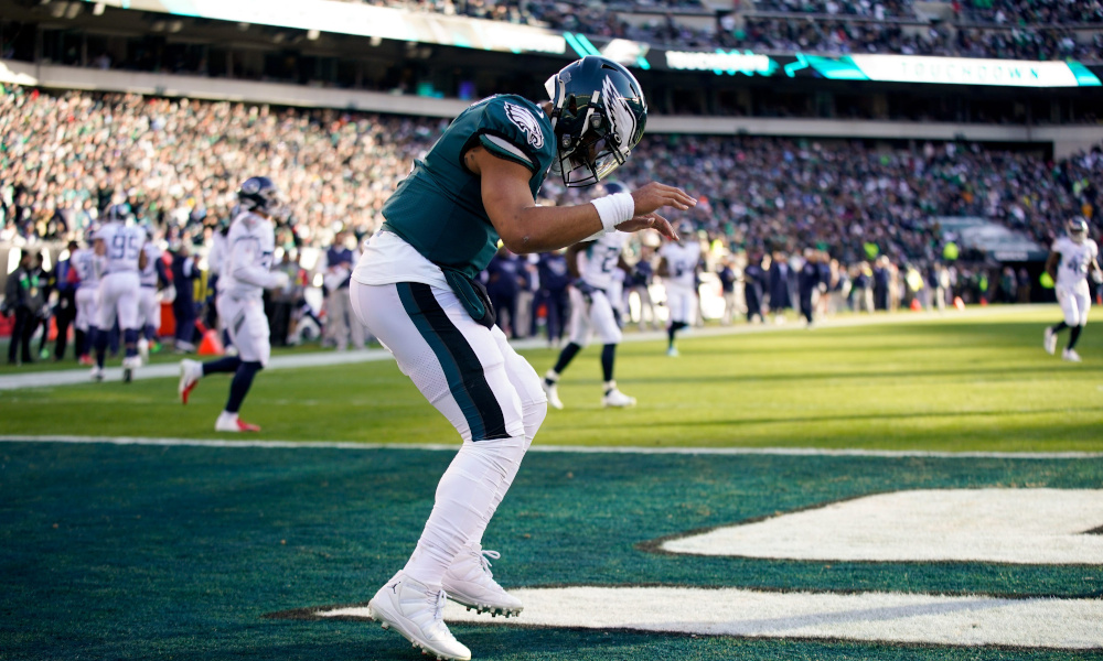 Eagles QB Jalen Hurts (#1) celebrates a rushing touchdown in Sunday's game against the Titans.
