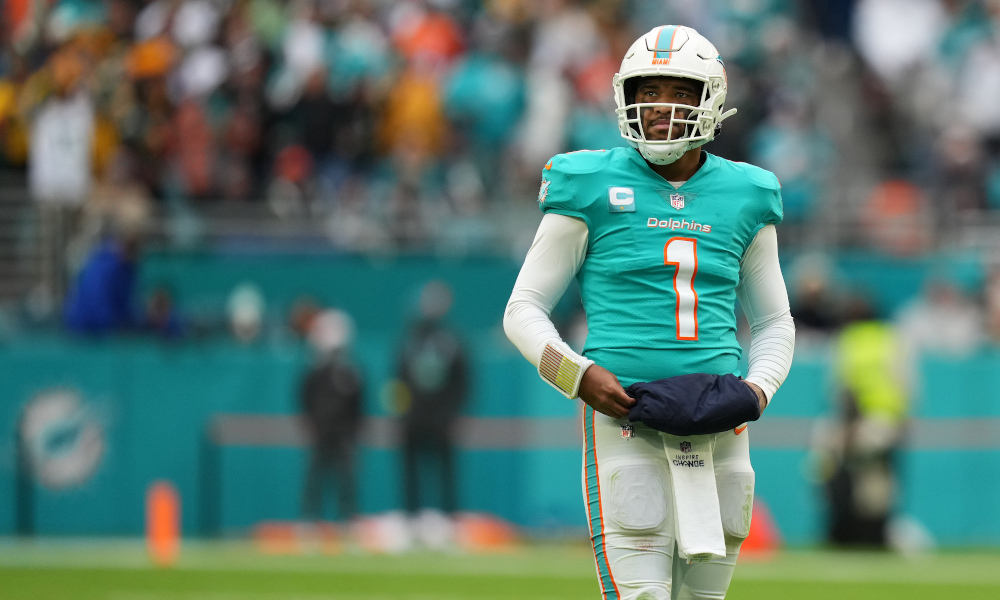 Dolphins QB Tua Tagovailoa stands on the field during second half matchup against Green Bay on Christmas.