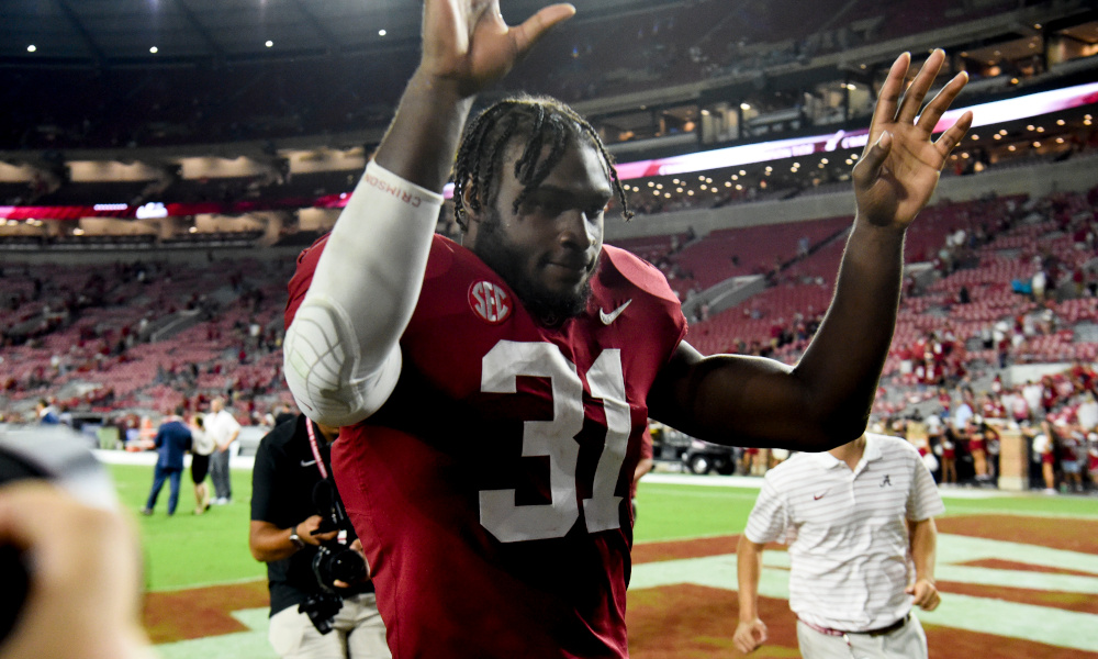 Alabama LB Will Anderson Jr. (#31) waves to fans at Bryant-Denny Stadium as he exits the field after victory over Vanderbilt in 2022 season.