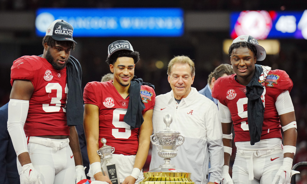 Alabama head coach Nick Saban on the Allstate Sugar Bowl stage with Bryce Young, Will Anderson Jr., and Jordan Battle to receive the Sugar Bowl trophy after defeating Kansas State.