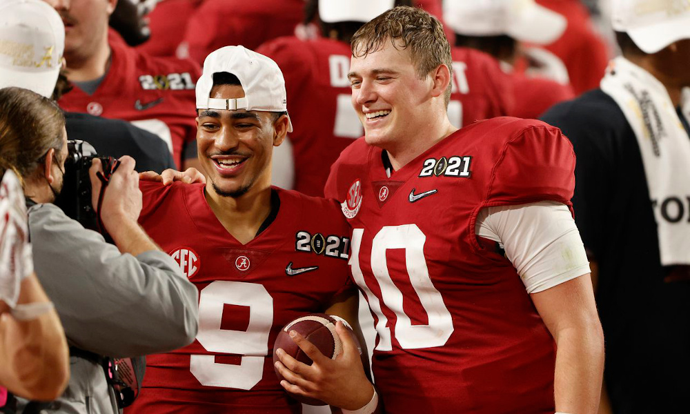 Mac Jones and Bryce Young celebrate Alabama's undefeated CFP National Championship in 2020.