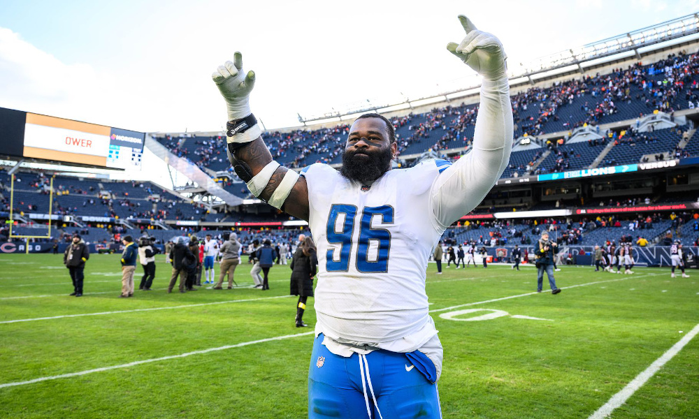 Detroit Lions DT Isaiah Buggs (#96) celebrates on the field after a big game.
