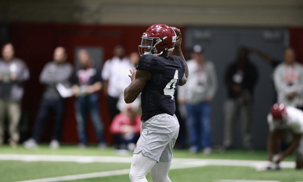 Jalen Milroe warms up in Alabama's indoor facility