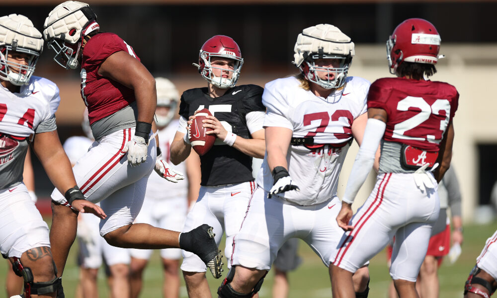 Ty Simpson throws behind the offensive line at practice