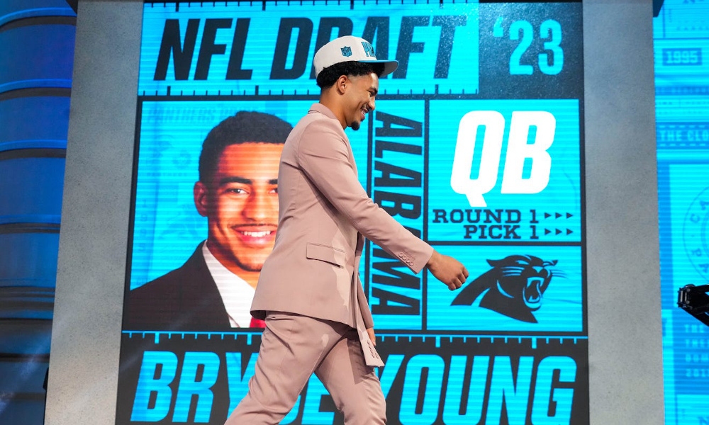 Bryce Young walking up to get his Panthers jersey as No. 1 pick in 2023 NFL Draft.