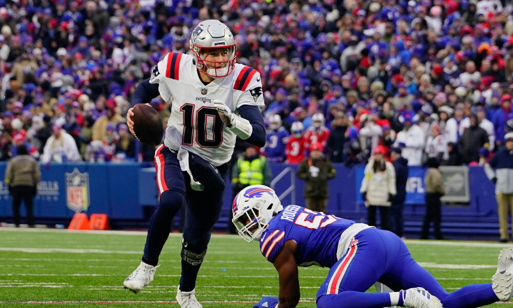 Mac Jones scrambles against the Buffalo Bills