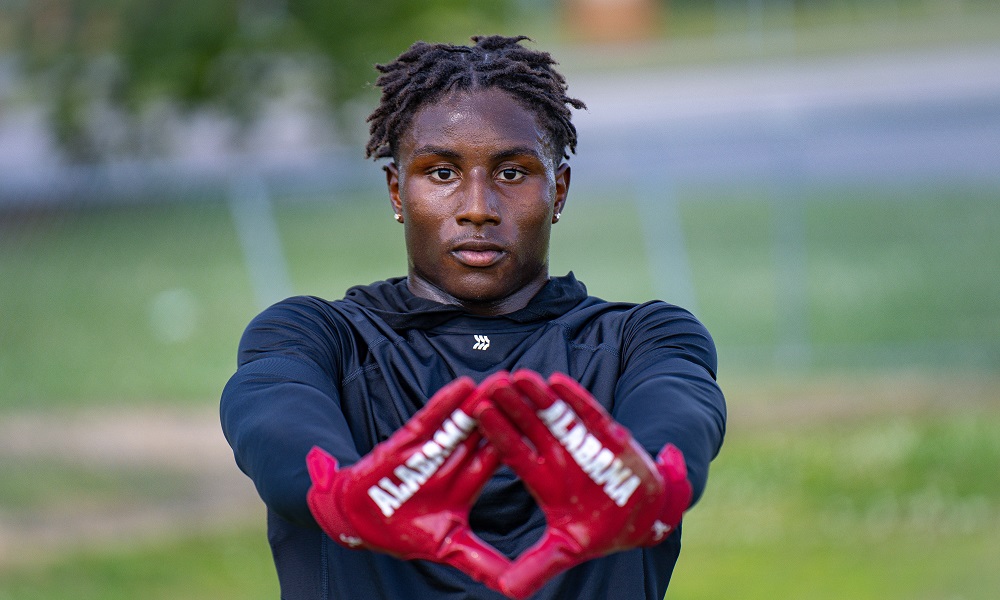 Anthony Rogers holding Alabama gloves