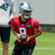 Bryce Young hands the ball off at practice with the Panthers