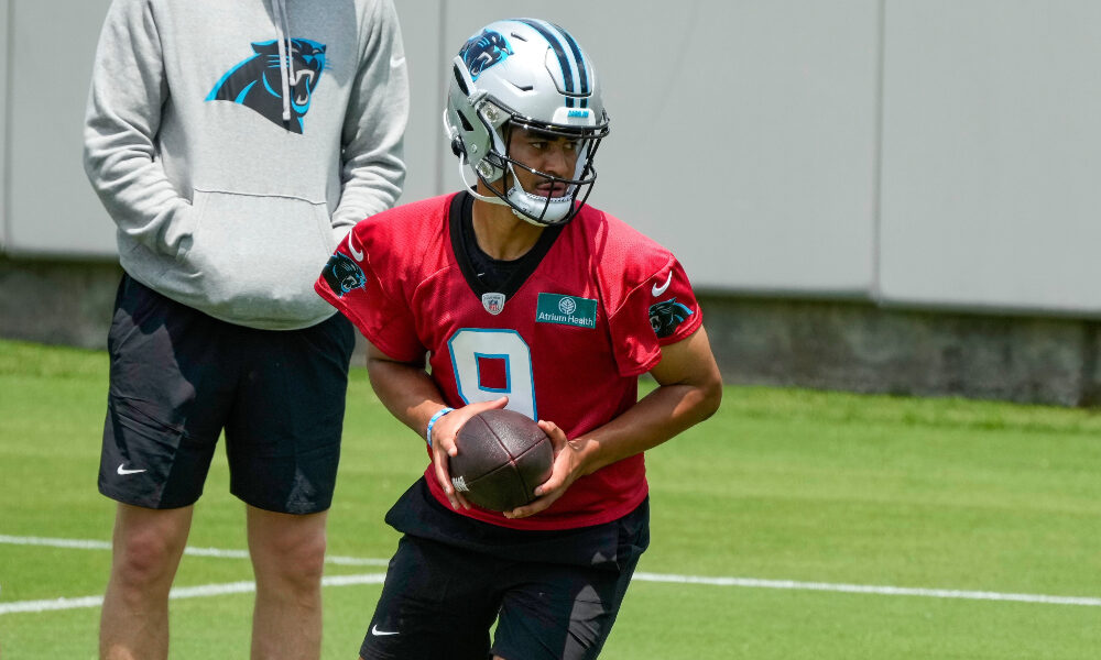 Bryce Young hands the ball off at practice with the Panthers