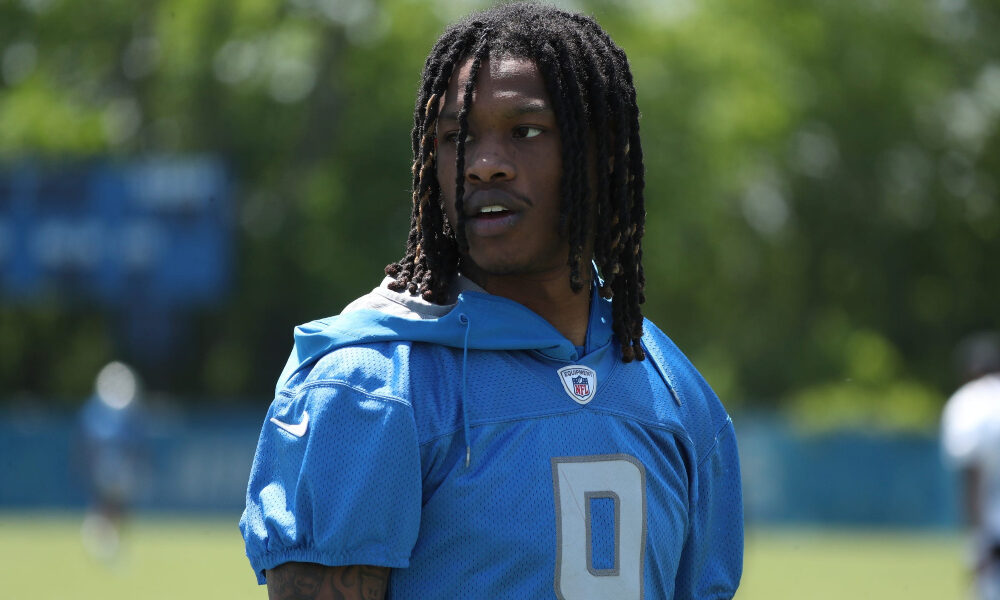 Jameson Williams looks to the sideline with is helmet off at Lions practice