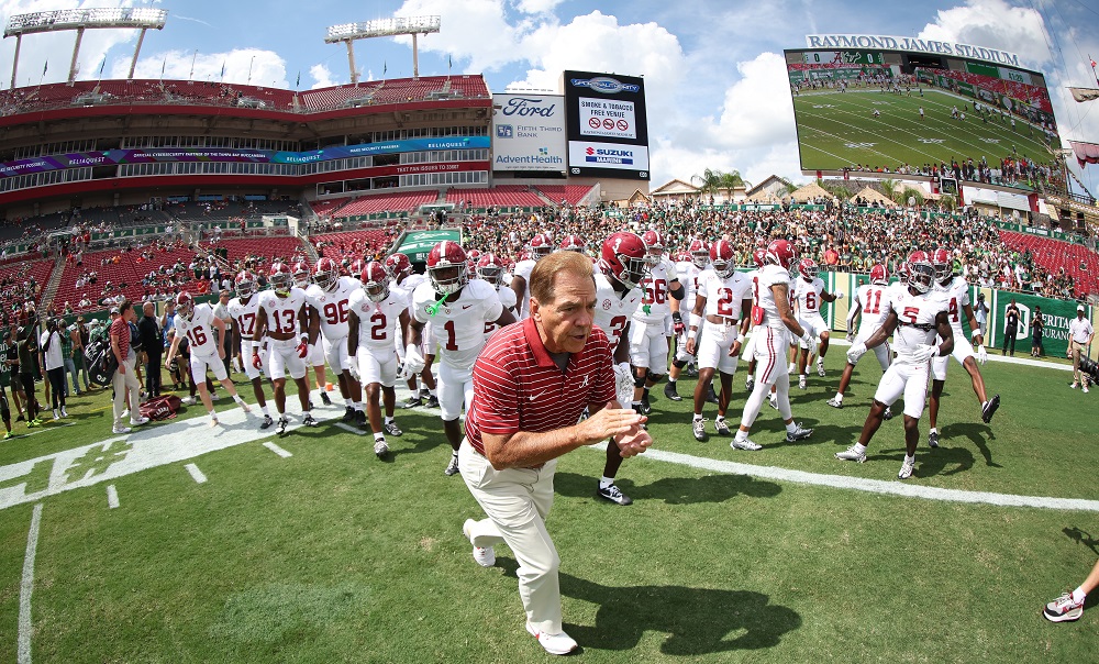 Alabama head coach Nick Sabans runs out onto the field against USF