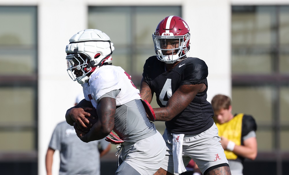 Alabama Jalen Milroe quarterback Jalen Milroe hands the ball to Roydell Williams