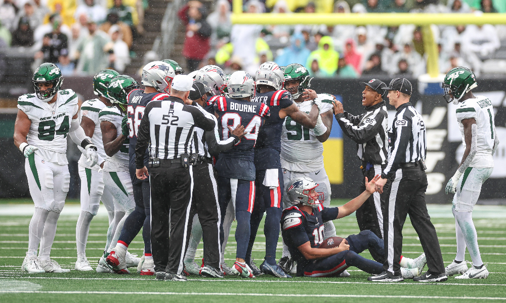 Patriots quarterback Mac Jones thrown to the ground against the Jets