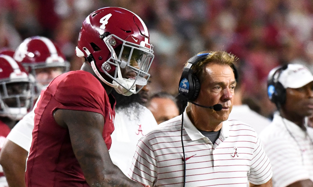 Alabama head coach Nick Saban shakes quarterback Jalen Milroe's hand