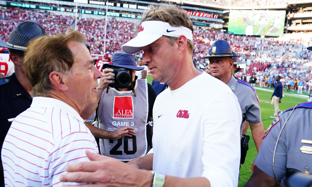 Alabama head coach Nick Saban and Ole Miss head coach Lane Kiffin meet at mid field