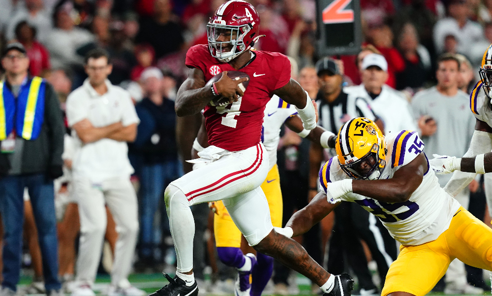 Alabama quarterback Jalen Milroe evades LSU defender