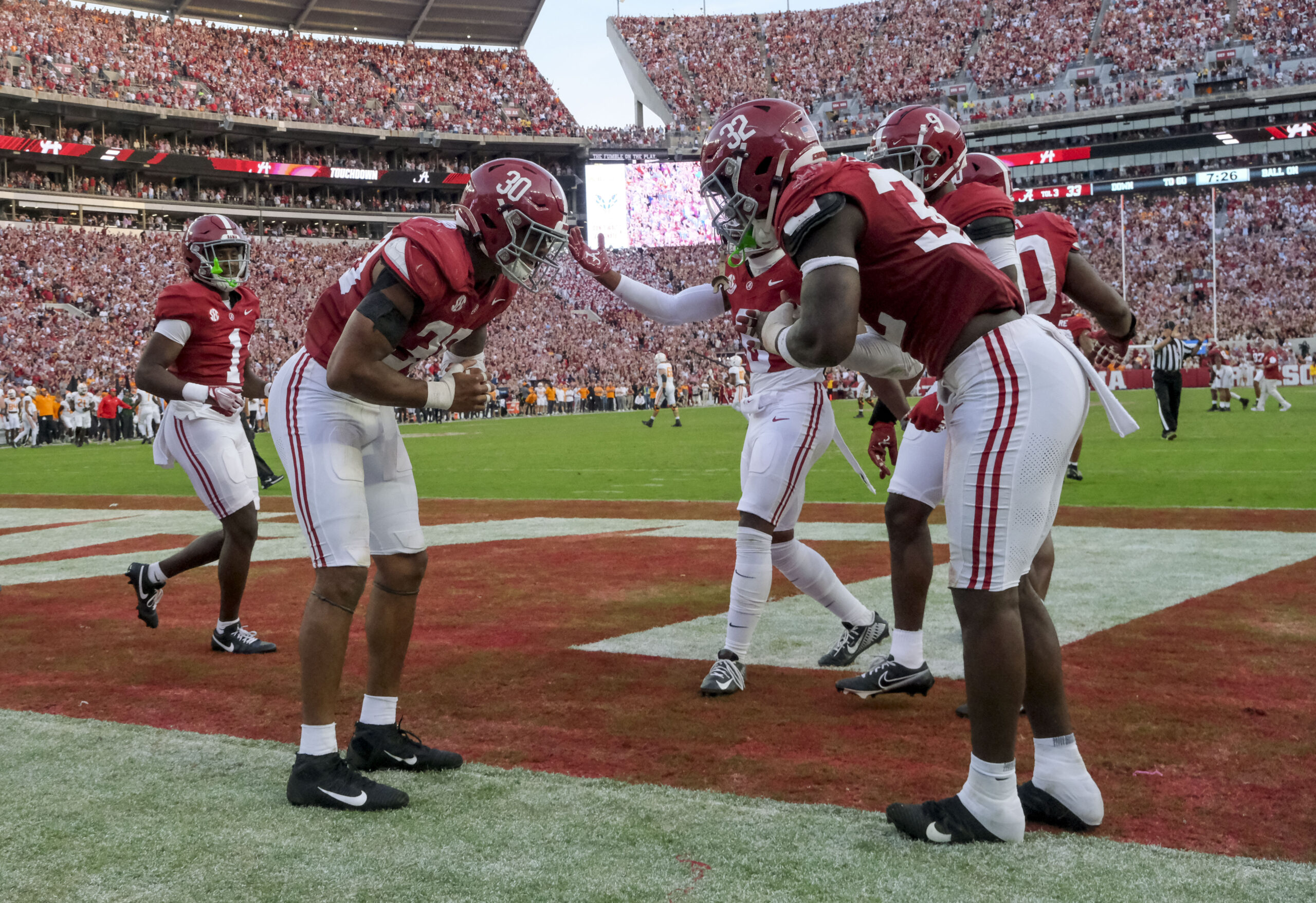 Alabama LBs Deontae Lawson (#32) and Jihaad Campbell (#30) celebrate a defensive touchdown in 2023 matchup against Tennessee.