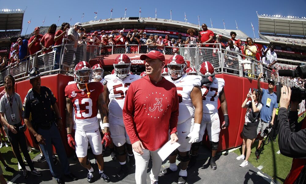 Alabama head coach Kalen DeBoer leads the Crimson Tide out of the tunnel on A-Day 2024.