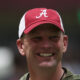 Alabama head coach Kalen DeBoer smiling in the indoor facility as the Crimson Tide is in 2024 spring practice.