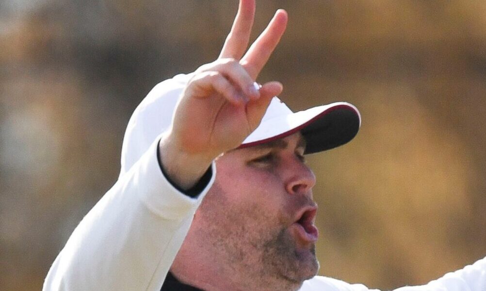 Alabama DC Kane Wommack giving signals on the field during 2024 Crimson Tide spring practice.