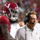 Alabama quarterback Jalen Milroe watches alongside Nick Saban