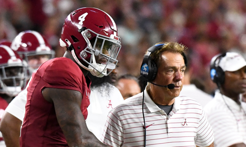 Alabama quarterback Jalen Milroe watches alongside Nick Saban