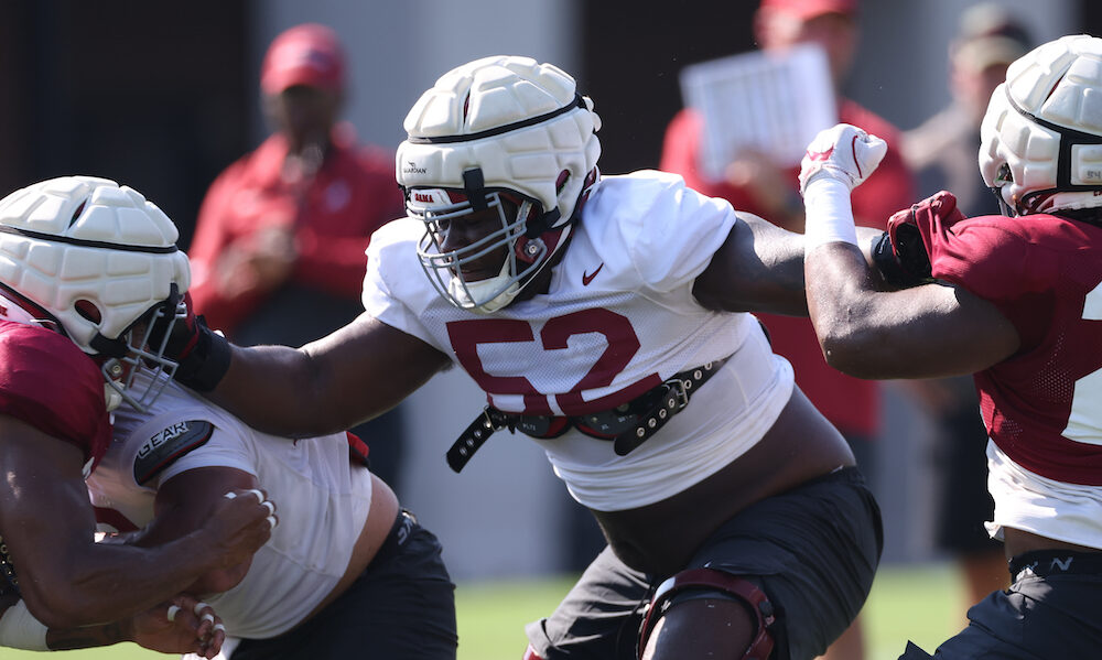 Alabama OL Tyler Booker (#52) blocking in practice during fall camp.