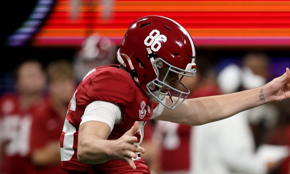 Alabama punter James Burnip (#86) kicks the ball in 2023 SEC Championship Game against Georgia.